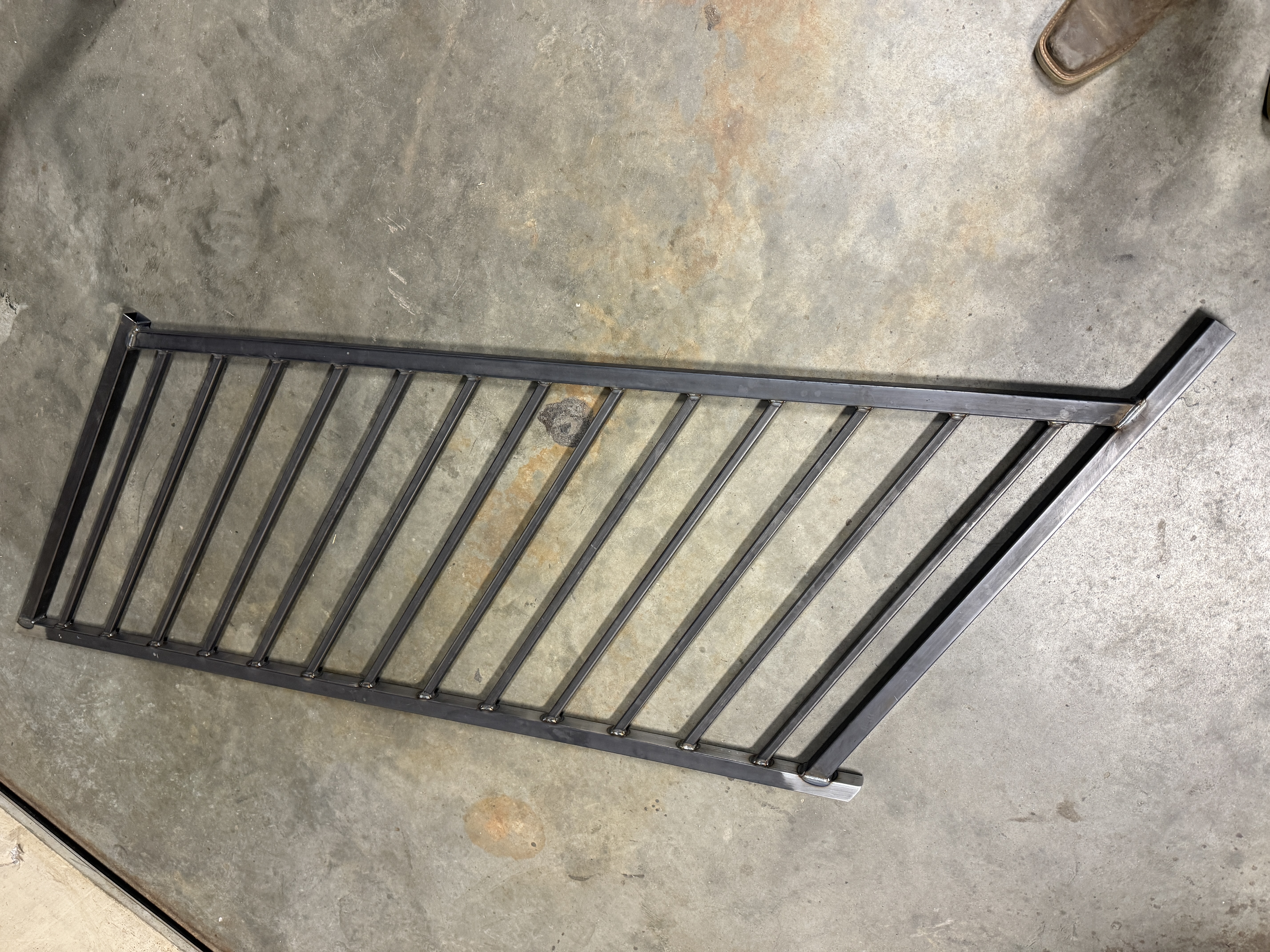 Welded steel railing section on the shop floor