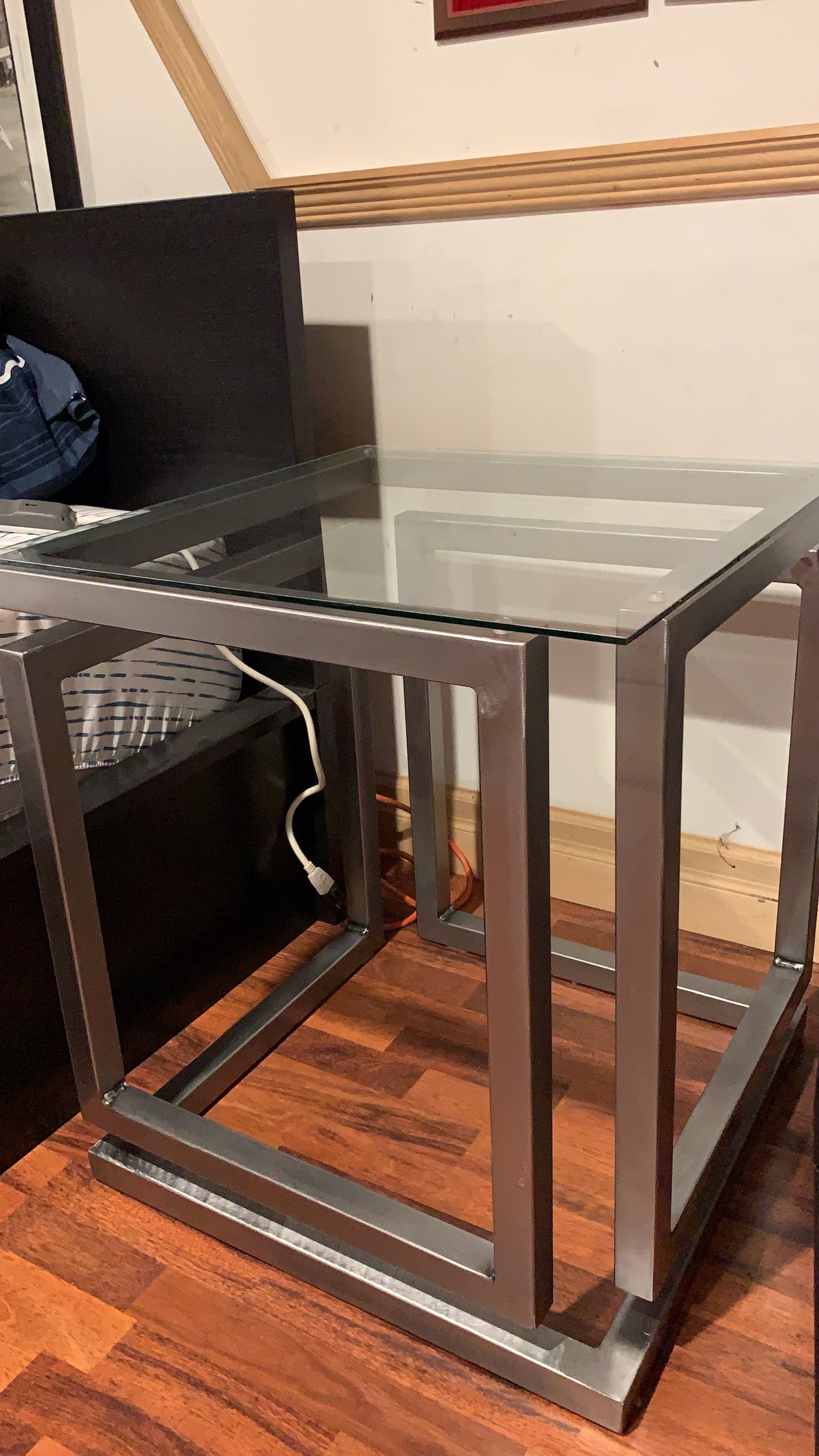 Side table with a steel frame and glass top