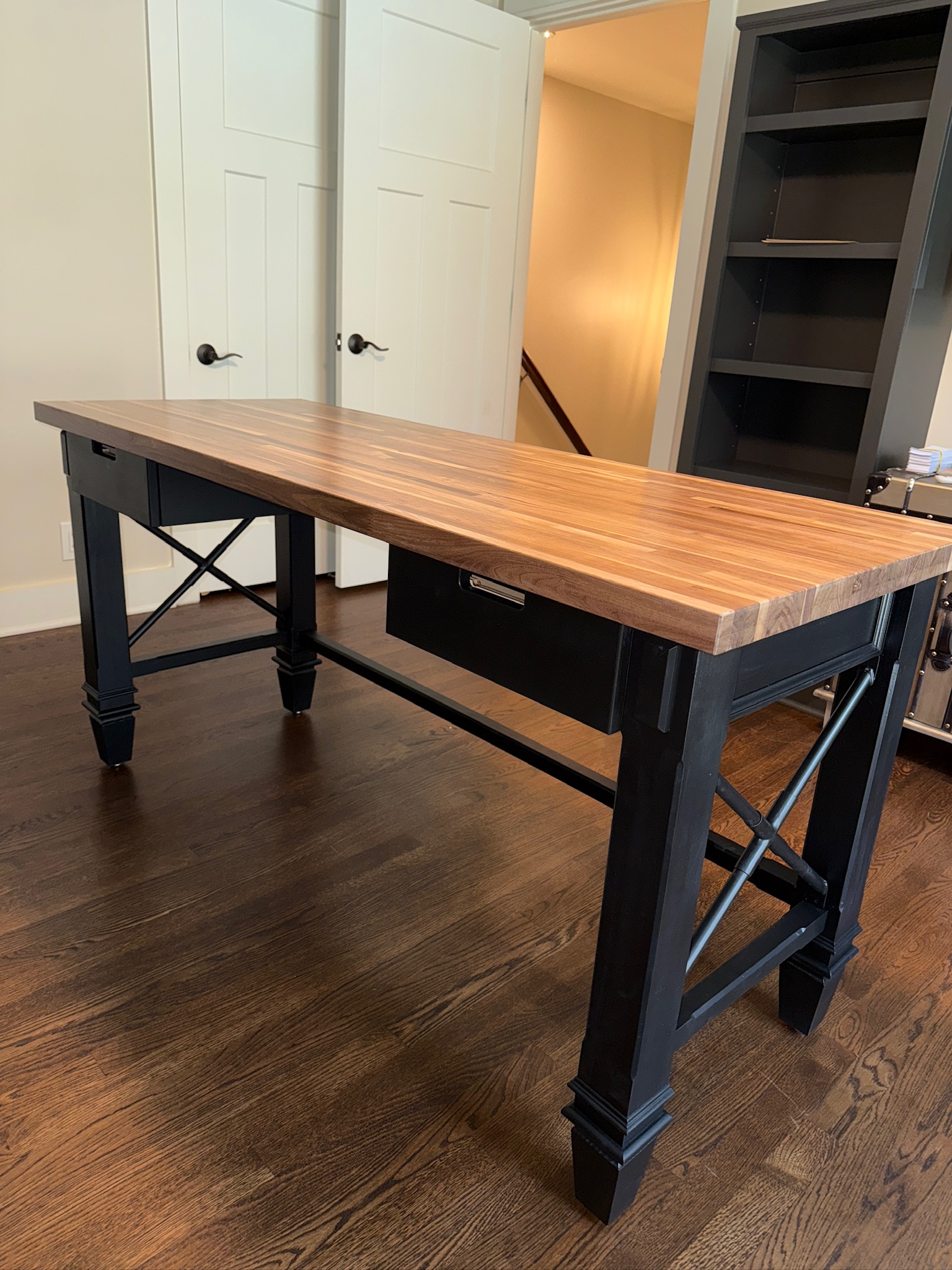Wood butcher-block desk on a black steel base