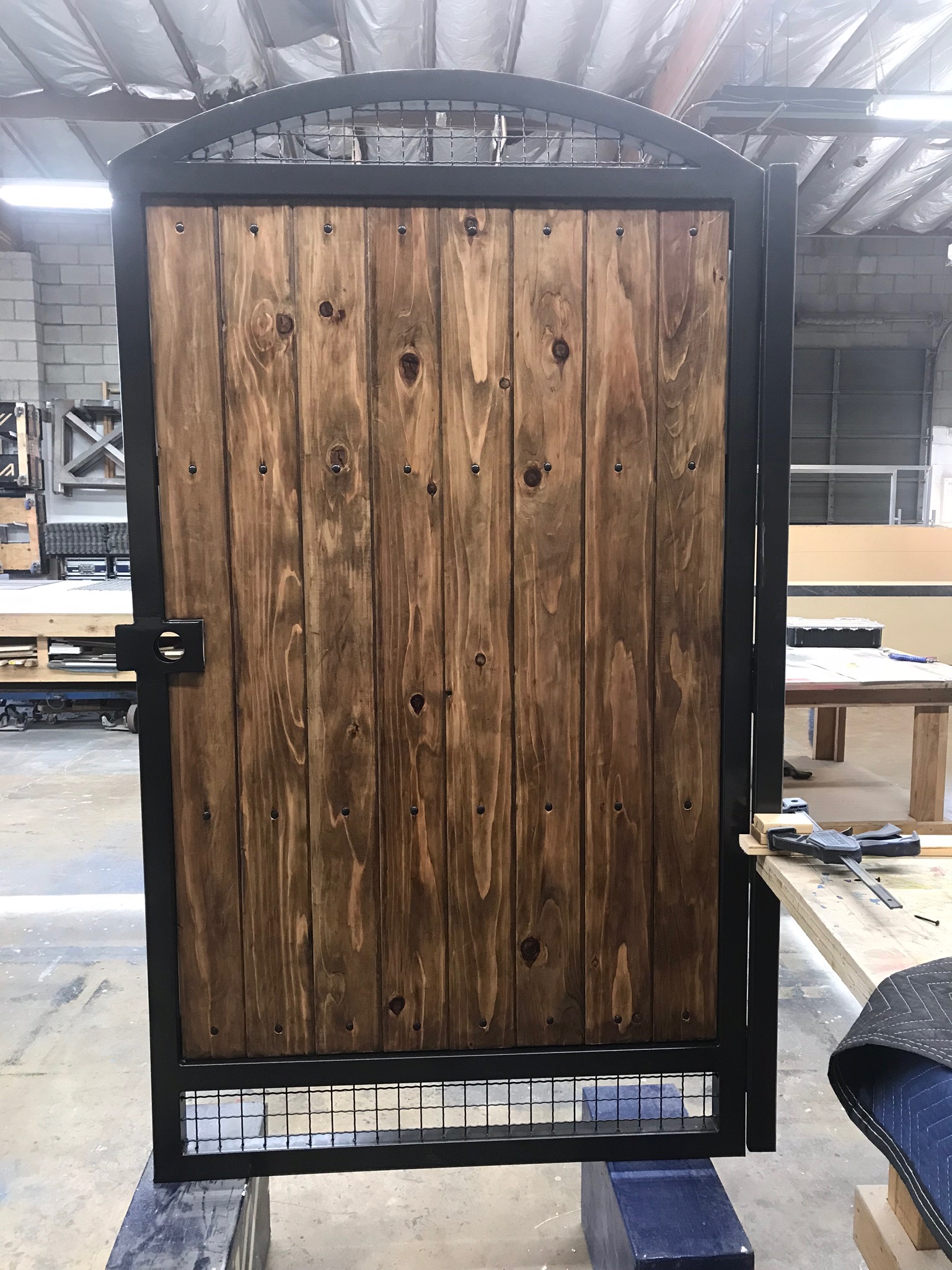 Custom wood gate in a black steel frame, built in the shop