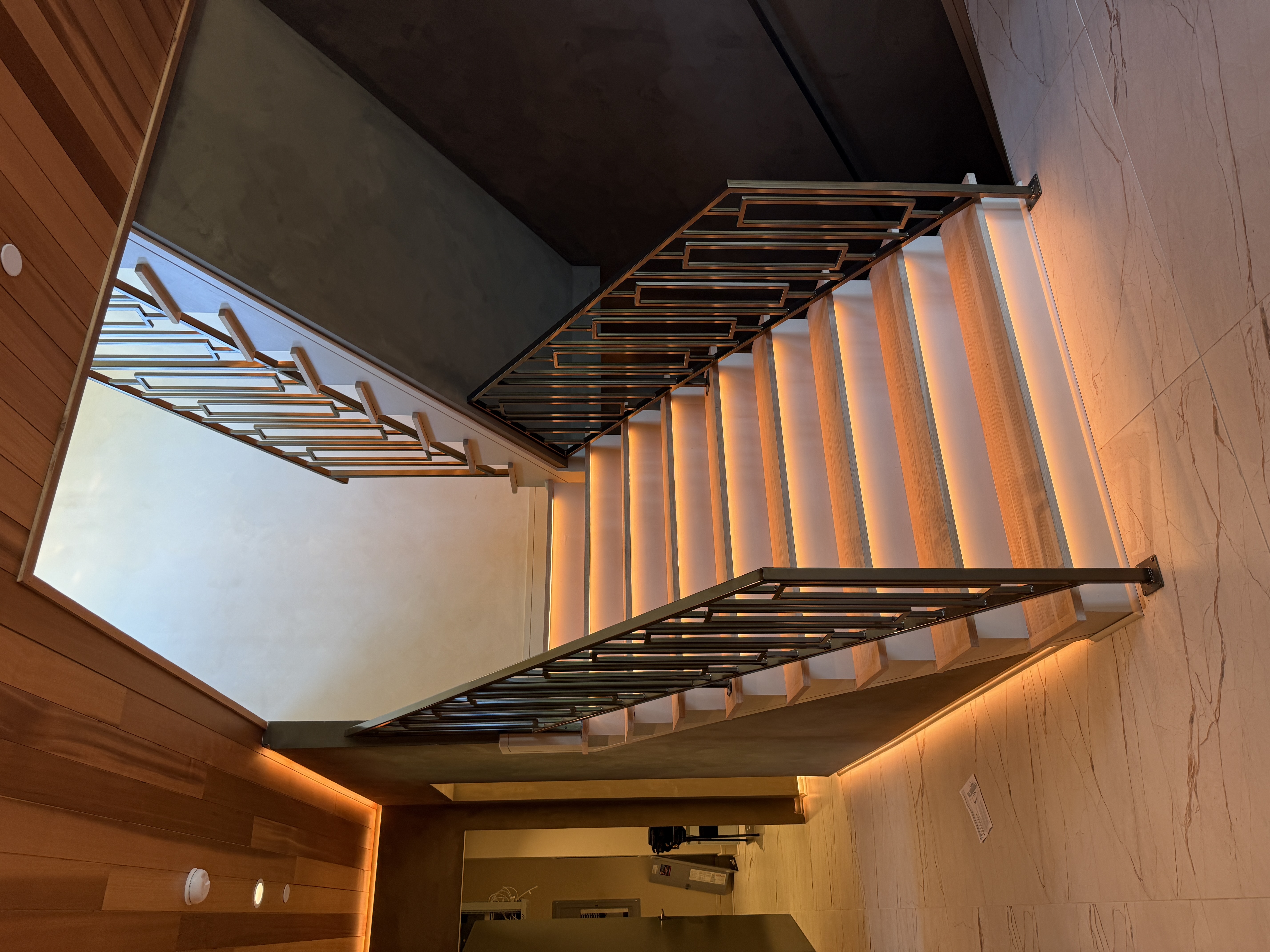 Interior stair with a black steel railing and wood treads