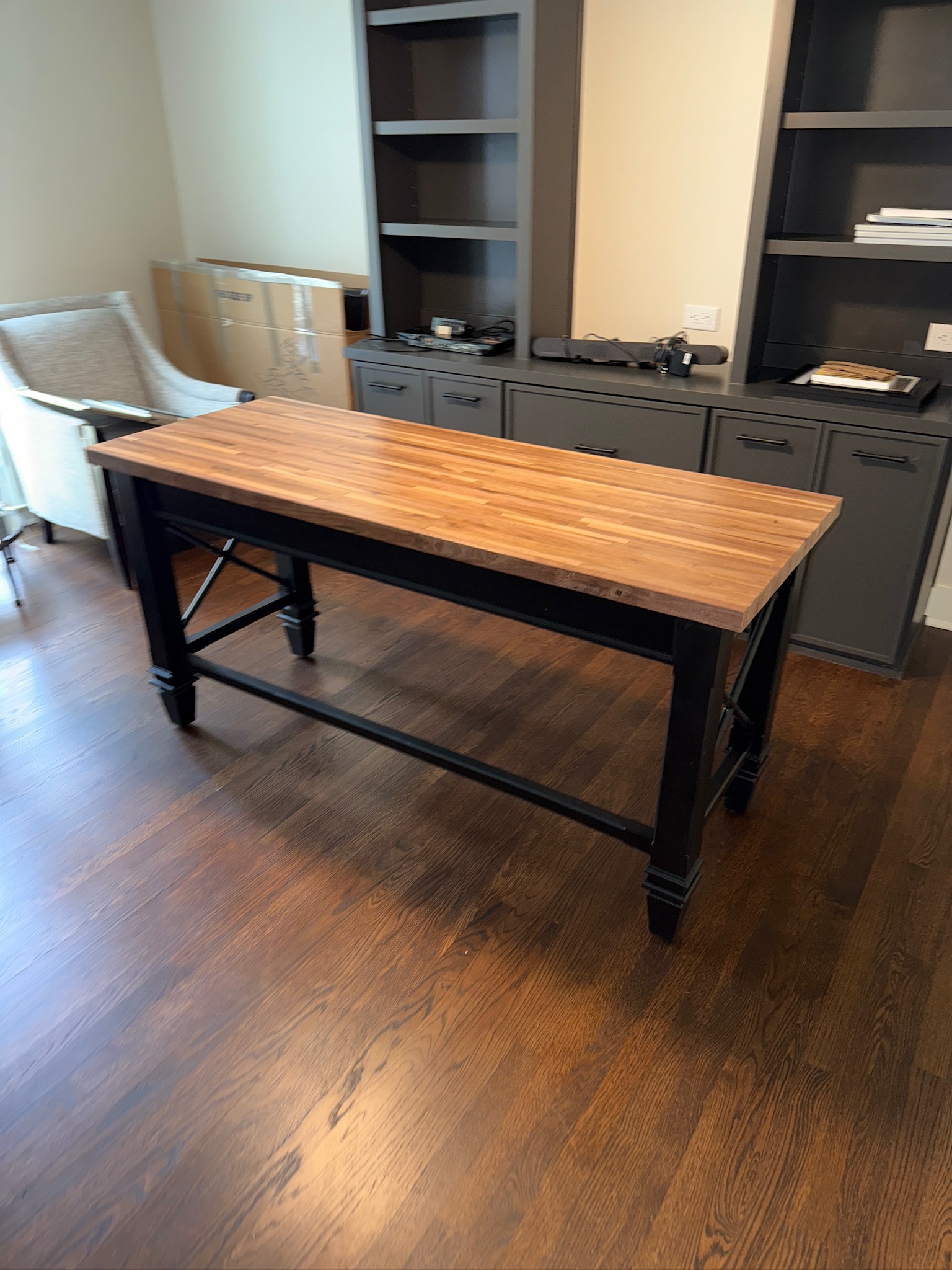Built-in cabinet and bookshelf beside a wood-top workbench