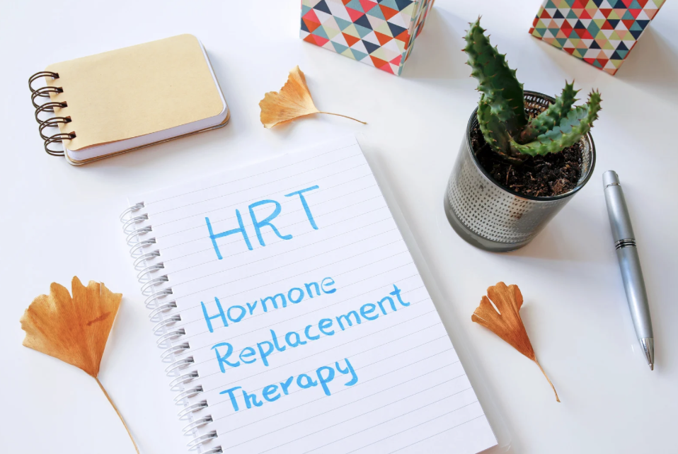 An open notebook with 'Hormone Replacement Therapy' handwritten across the page, on a calm, styled desk