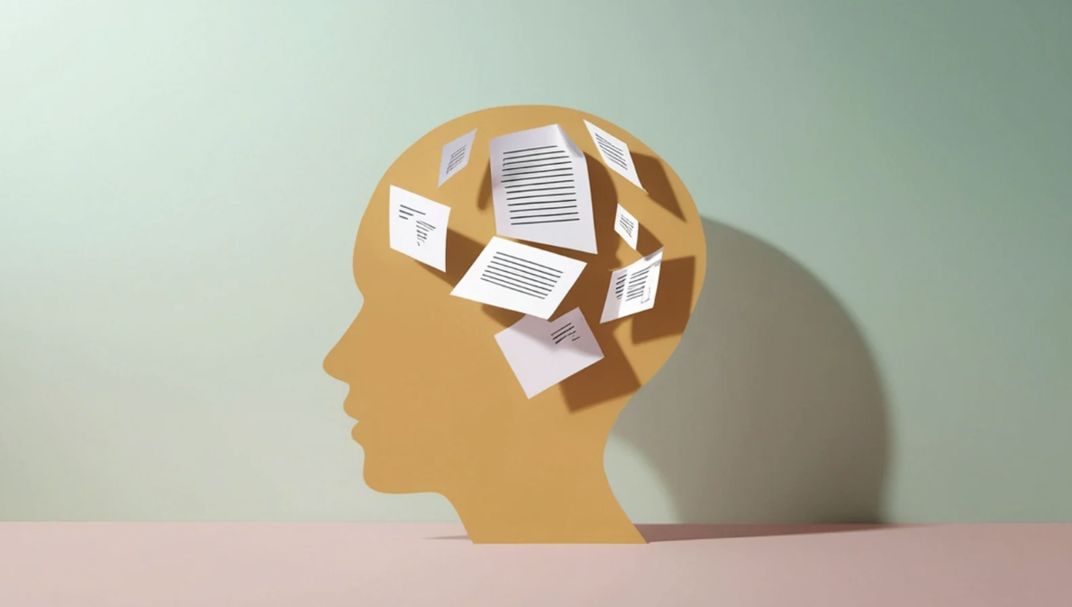A silhouette of a head filled with scattered pages, representing thought patterns