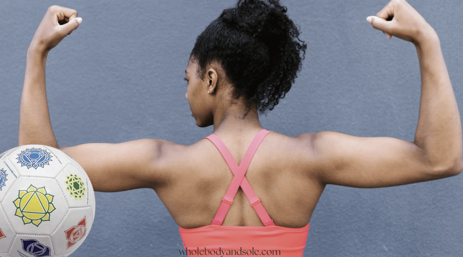Helen flexing her biceps beside a chakra-marked Cognomovement ball