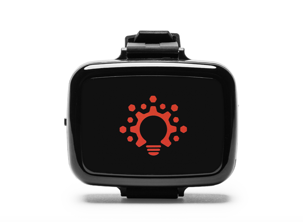 The Solex 660 Band, a black watch-style red light device with a red logo on its face