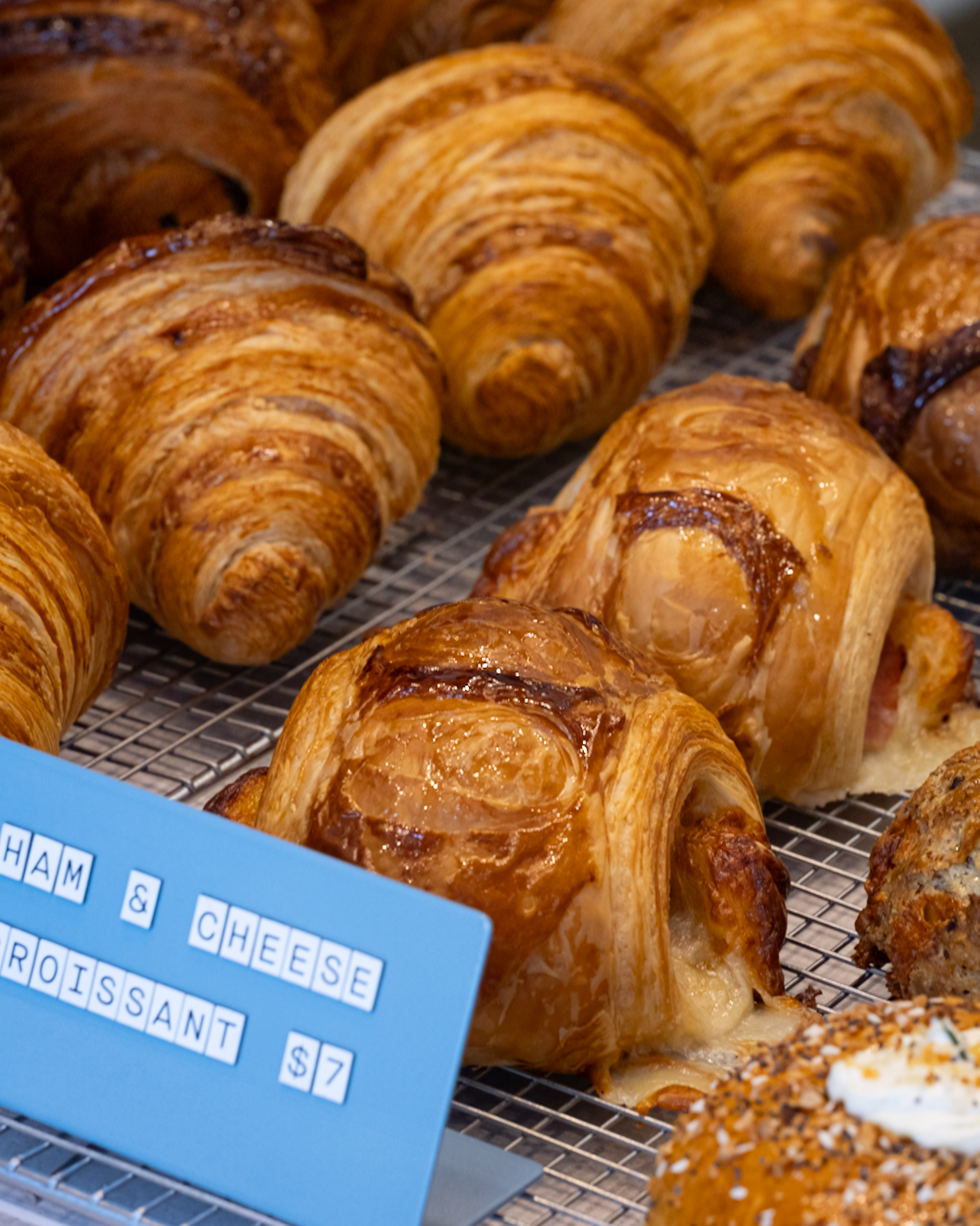 A golden ham and cheese croissant with melted cheese